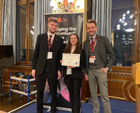 Liverpool Hope University students, Harry Bates, Eimhear Byrne and George Couch, standing with their Outstanding Delegation certificate at the 2023 BISA Model NATO held at the Foreign Commonwealth and Development Office.